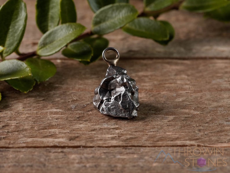 These raw gray Muonionalusta meteorite pendants are small chunk nugget in shape. Crystals are nature-made therefore each one is unique in appearance.