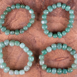 These pale Green Aventurine crystal bracelets have tumbled beads strung on elastic for an endless bracelet.  
Crystals are nature-made therefore each one is unique in appearance.