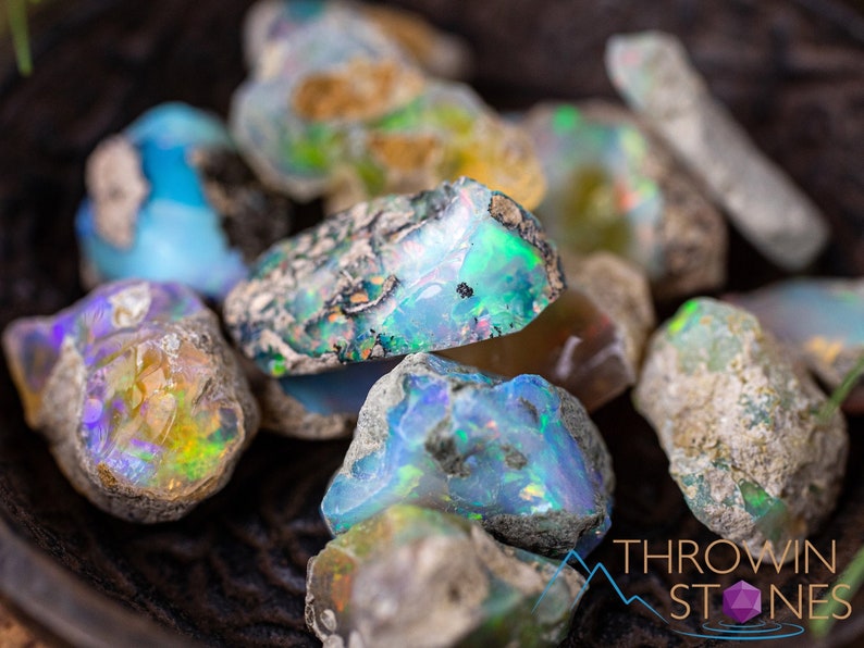 These raw Opal crystals are chunk shaped and rainbow colored with patches of tan matrix.
Crystals are nature-made therefore each one is unique in appearance.