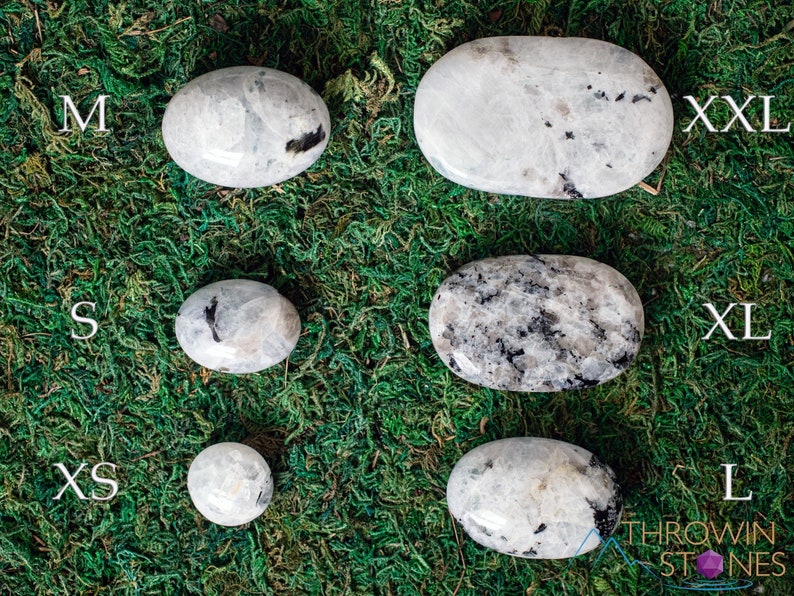 These Moonstone crystal carved polished palm stones range in a variety of handheld sizes.  Rainbow moonstone is white with black flecks and rainbow flashes.
Crystals are nature-made therefore each one is unique in appearance.