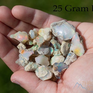 These raw Opal crystals are chunk shaped and rainbow colored with patches of tan matrix.
Crystals are nature-made therefore each one is unique in appearance.