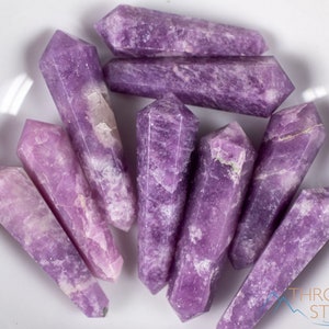 These Lepidolite crystal carved polished double terminated points range in a variety of handheld sizes.  Lepidolite  is mottled light to dark pinkish purple with white splotches.
Crystals are nature-made therefore each one is unique in appearance.