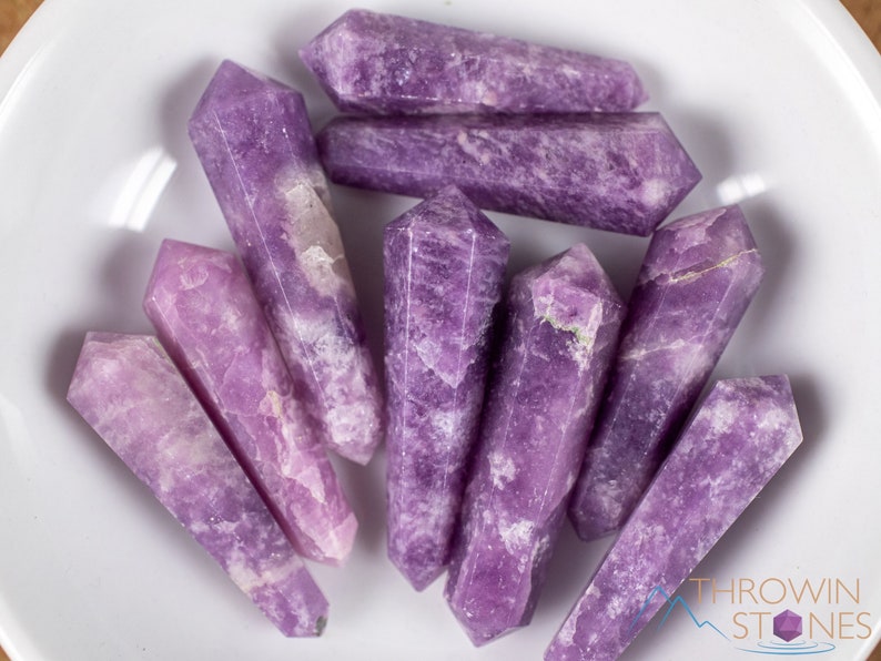 These Lepidolite crystal carved polished double terminated points range in a variety of handheld sizes.  Lepidolite  is mottled light to dark pinkish purple with white splotches.
Crystals are nature-made therefore each one is unique in appearance.