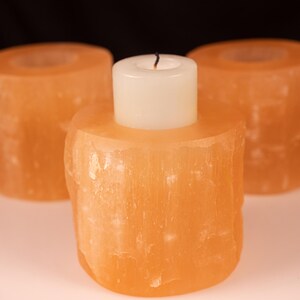 These peachy orange Selenite crystal carved raw cylindrical votive candle holders range in a variety of sizes.  
Crystals are nature-made therefore each one is unique in appearance.
