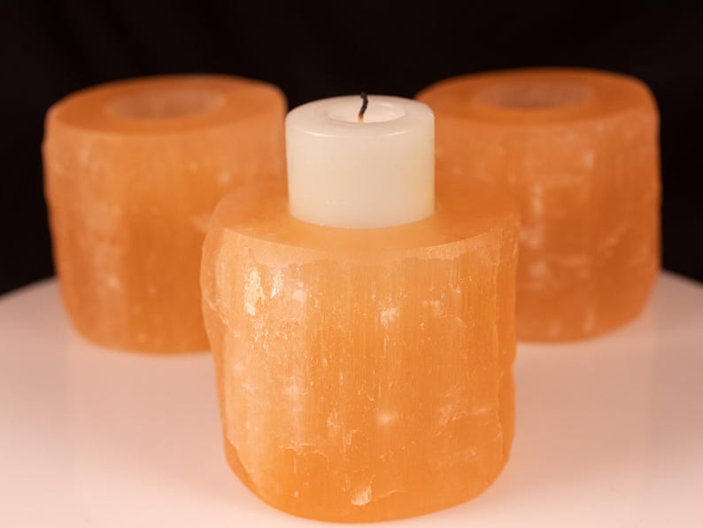 These peachy orange Selenite crystal carved raw cylindrical votive candle holders range in a variety of sizes.  
Crystals are nature-made therefore each one is unique in appearance.
