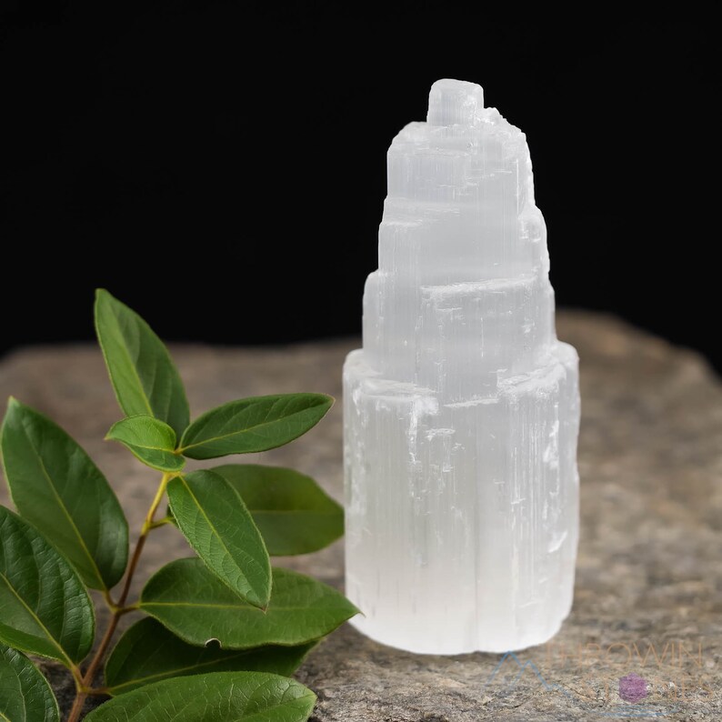 These white Selenite crystal carved raw tiered towers range in a variety of handheld sizes.  
Crystals are nature-made therefore each one is unique in appearance.