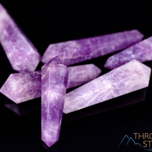 These Lepidolite crystal carved polished double terminated points range in a variety of handheld sizes.  Lepidolite  is mottled light to dark pinkish purple with white splotches.
Crystals are nature-made therefore each one is unique in appearance.