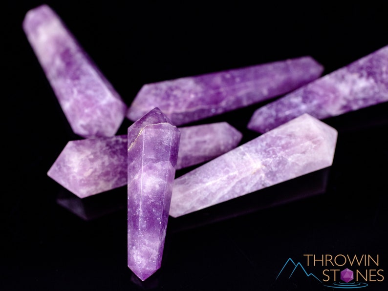 These Lepidolite crystal carved polished double terminated points range in a variety of handheld sizes.  Lepidolite  is mottled light to dark pinkish purple with white splotches.
Crystals are nature-made therefore each one is unique in appearance.