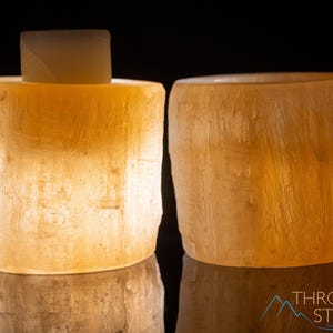 These peachy orange Selenite crystal carved raw cylindrical votive candle holders range in a variety of sizes.  
Crystals are nature-made therefore each one is unique in appearance.