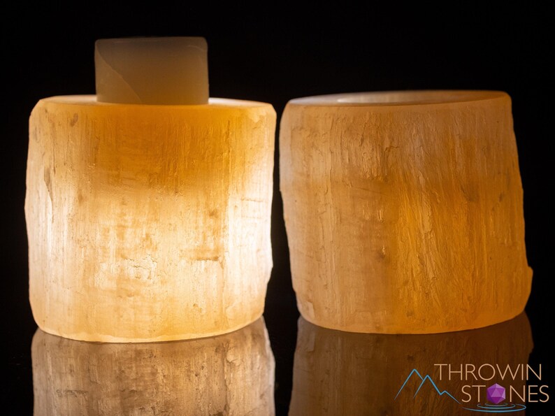 These peachy orange Selenite crystal carved raw cylindrical votive candle holders range in a variety of sizes.  
Crystals are nature-made therefore each one is unique in appearance.