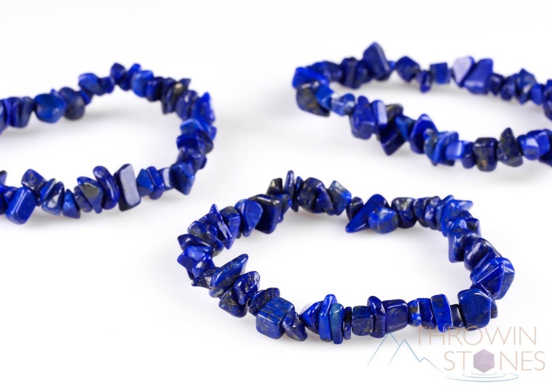 Handcrafted Lapis Lazuli chip bracelet. These blue, tumbled chips, are drilled and strung on an elastic cord. Each crystal bracelet is unique in shape, color, and pattern and has a wrist circumference of approximately 6 inches. Listing has variations