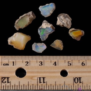 These raw Opal crystals are chunk shaped and rainbow colored with patches of tan matrix.
Crystals are nature-made therefore each one is unique in appearance.