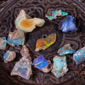 These raw Opal crystals are chunk shaped and rainbow colored with patches of tan matrix.
Crystals are nature-made therefore each one is unique in appearance.