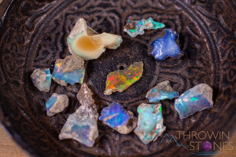 These raw Opal crystals are chunk shaped and rainbow colored with patches of tan matrix.
Crystals are nature-made therefore each one is unique in appearance.