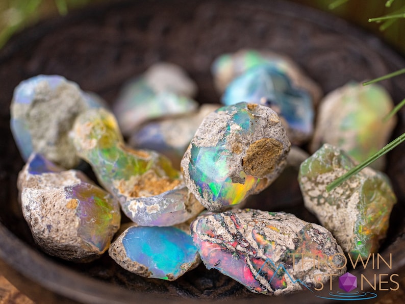 These raw Opal crystals are chunk shaped and rainbow colored with patches of tan matrix.
Crystals are nature-made therefore each one is unique in appearance.