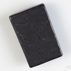 May include: A black rectangular slab of polished obsidian with a marbled pattern.