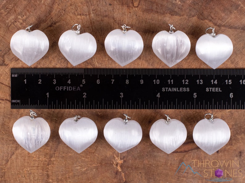 These chatoyant white Selenite crystal pendants are heart shaped, with a silver bail. 
Crystals are nature-made therefore each one is unique in appearance.