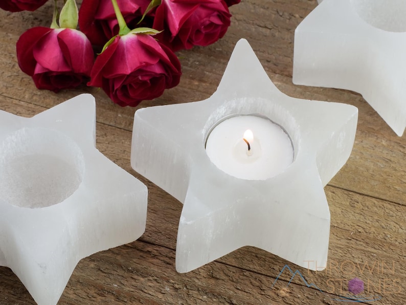 These are white Selenite crystal carved candle holders in the shape of a star.
Crystals are nature-made therefore each one is unique in appearance.