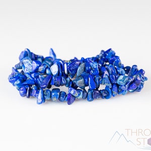 Handcrafted Lapis Lazuli chip bracelet. These blue, tumbled chips, are drilled and strung on an elastic cord. Each crystal bracelet is unique in shape, color, and pattern and has a wrist circumference of approximately 6 inches. Listing has variations