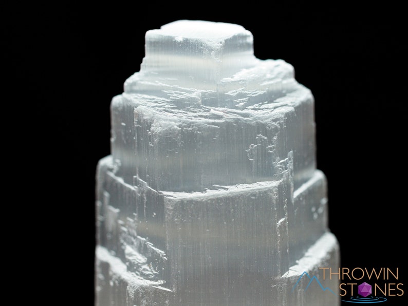 These white Selenite crystal carved raw tiered towers range in a variety of handheld sizes.  
Crystals are nature-made therefore each one is unique in appearance.