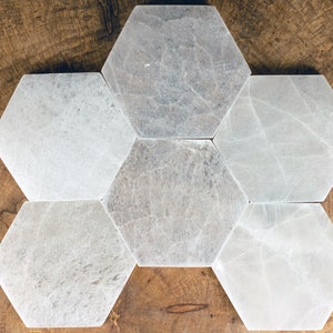 These are white Selenite crystal carved polished hexagon plates.
Crystals are nature-made therefore each one is unique in appearance.