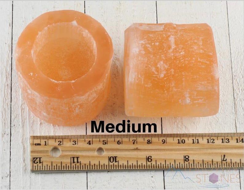 These peachy orange Selenite crystal carved raw cylindrical votive candle holders range in a variety of sizes.  
Crystals are nature-made therefore each one is unique in appearance.
