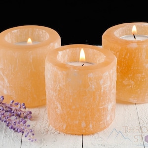 These peachy orange Selenite crystal carved raw cylindrical votive candle holders range in a variety of sizes.  
Crystals are nature-made therefore each one is unique in appearance.