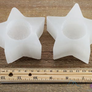 These are white Selenite crystal carved candle holders in the shape of a star.
Crystals are nature-made therefore each one is unique in appearance.