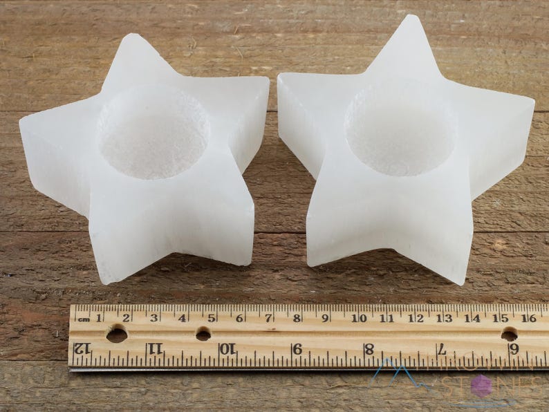 These are white Selenite crystal carved candle holders in the shape of a star.
Crystals are nature-made therefore each one is unique in appearance.