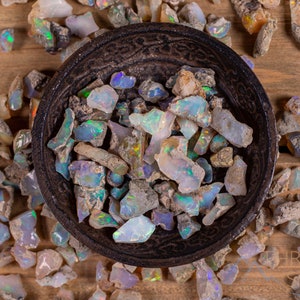 These raw Opal crystals are chunk shaped and rainbow colored with patches of tan matrix.
Crystals are nature-made therefore each one is unique in appearance.