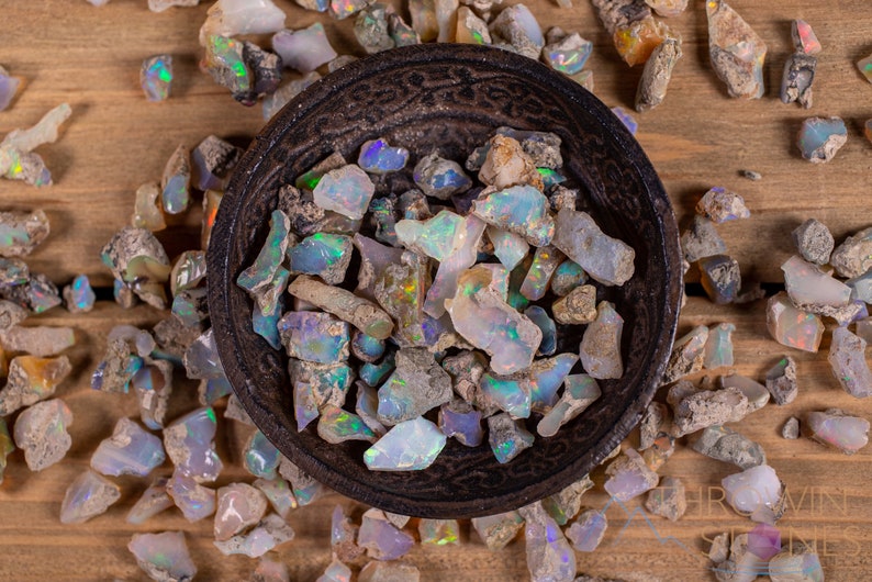 These raw Opal crystals are chunk shaped and rainbow colored with patches of tan matrix.
Crystals are nature-made therefore each one is unique in appearance.