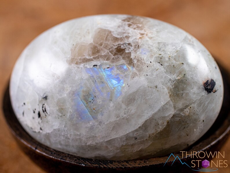These Moonstone crystal carved polished palm stones range in a variety of handheld sizes.  Rainbow moonstone is white with black flecks and rainbow flashes.
Crystals are nature-made therefore each one is unique in appearance.