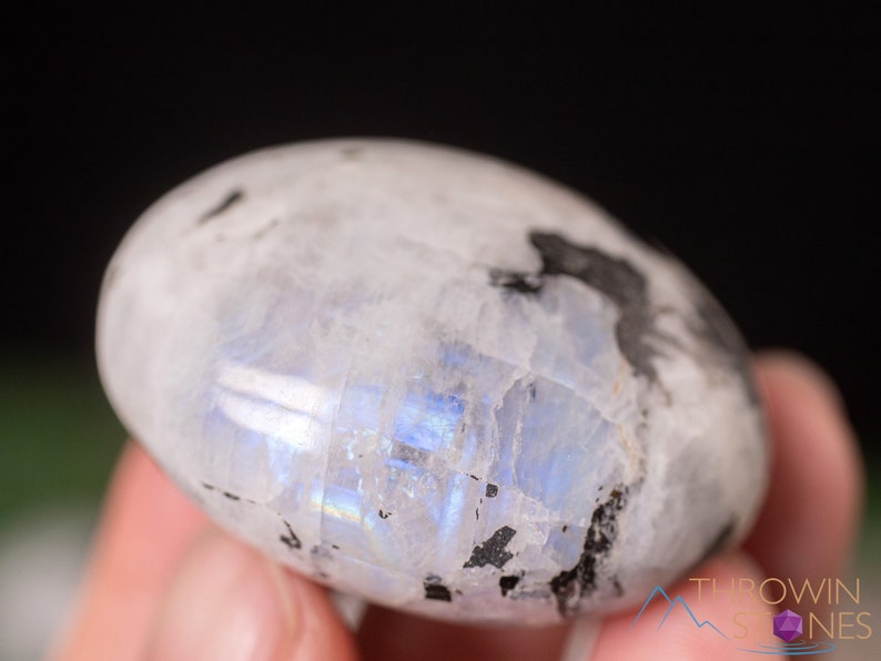 These Moonstone crystal carved polished palm stones range in a variety of handheld sizes.  Rainbow moonstone is white with black flecks and rainbow flashes.
Crystals are nature-made therefore each one is unique in appearance.