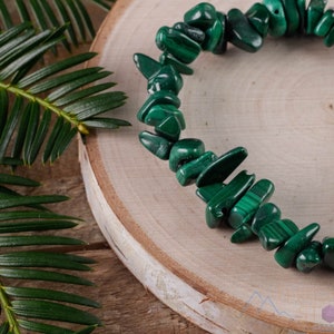 Handcrafted Malachite chip bracelet. These green, tumbled chips, are drilled, and strung on an elastic cord, to create an endless bracelet. Each crystal bracelet is unique in shape, and color, and has a wrist circumference of approximately 6 inches.
