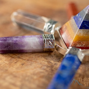 These crystal carved polished generators are a rainbow chakra crystal pyramid surrounded by 7 small points in each color of the rainbow chakras.
Crystals are nature-made therefore each one is unique in appearance.