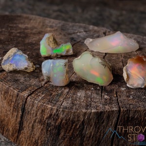 These raw Opal crystals are chunk shaped and rainbow colored with patches of tan matrix.
Crystals are nature-made therefore each one is unique in appearance.