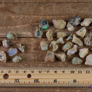 These raw Opal crystals are chunk shaped and rainbow colored with patches of tan matrix.
Crystals are nature-made therefore each one is unique in appearance.