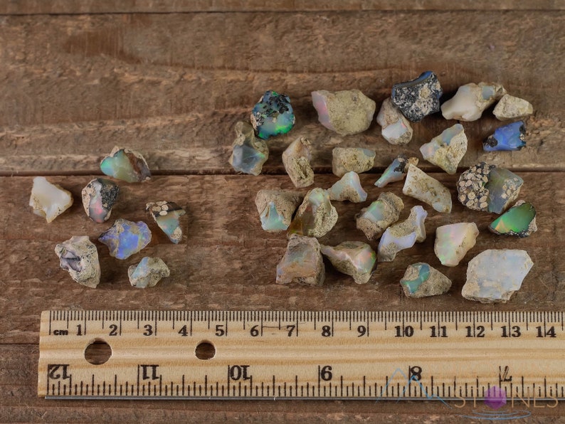 These raw Opal crystals are chunk shaped and rainbow colored with patches of tan matrix.
Crystals are nature-made therefore each one is unique in appearance.