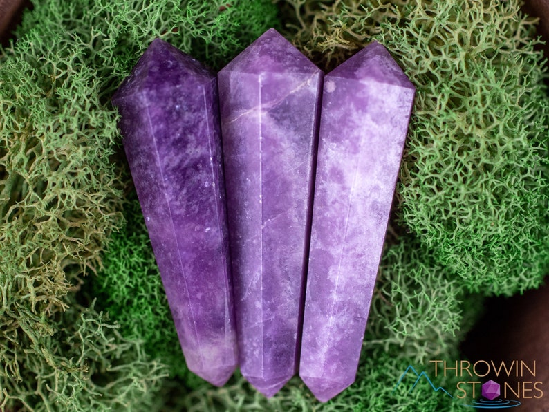 These Lepidolite crystal carved polished double terminated points range in a variety of handheld sizes.  Lepidolite  is mottled light to dark pinkish purple with white splotches.
Crystals are nature-made therefore each one is unique in appearance.