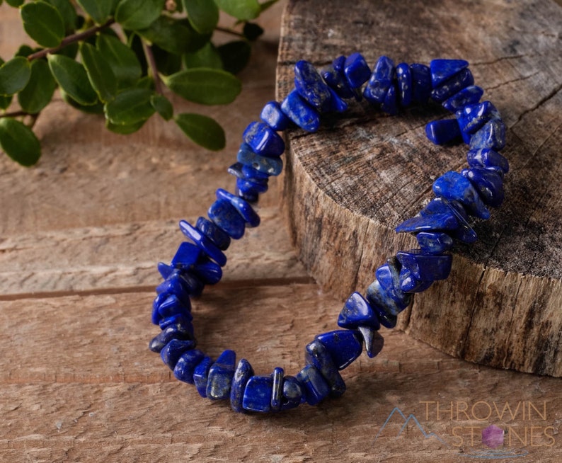 Handcrafted Lapis Lazuli chip bracelet. These blue, tumbled chips, are drilled and strung on an elastic cord. Each crystal bracelet is unique in shape, color, and pattern and has a wrist circumference of approximately 6 inches. Listing has variations