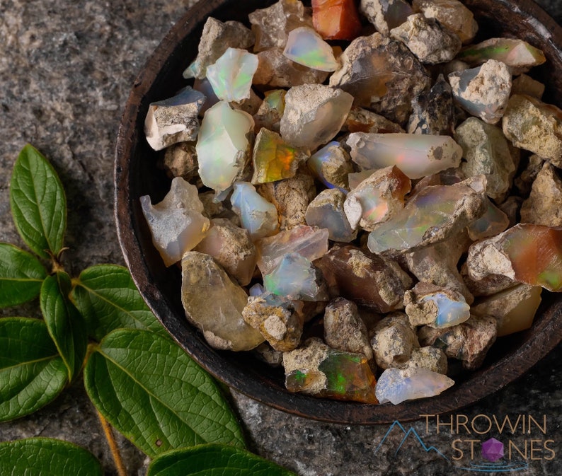 These raw Opal crystals are chunk shaped and rainbow colored with patches of tan matrix.
Crystals are nature-made therefore each one is unique in appearance.