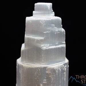 These white Selenite crystal carved raw tiered towers range in a variety of handheld sizes.  
Crystals are nature-made therefore each one is unique in appearance.