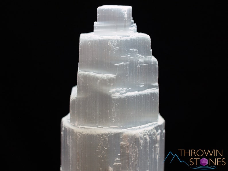 These white Selenite crystal carved raw tiered towers range in a variety of handheld sizes.  
Crystals are nature-made therefore each one is unique in appearance.