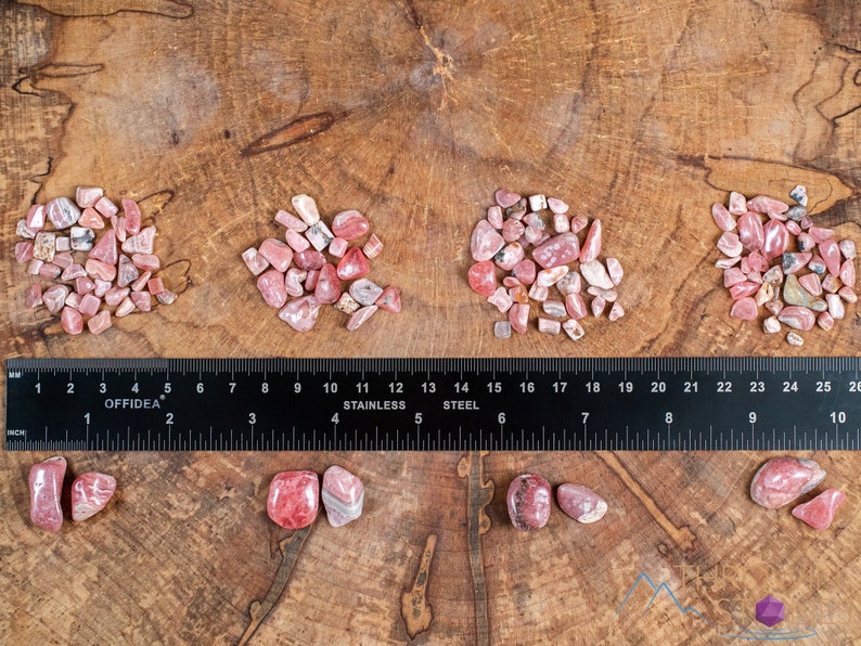 Rhodochrosite Crystal Chips. These stones are light pink to bright pink and often include a white banding. They are great for jewelry making and crystal decor. Each specimen is unique and varies in color, shape, and pattern. Listing has variations.