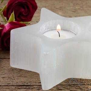 These are white Selenite crystal carved candle holders in the shape of a star.
Crystals are nature-made therefore each one is unique in appearance.