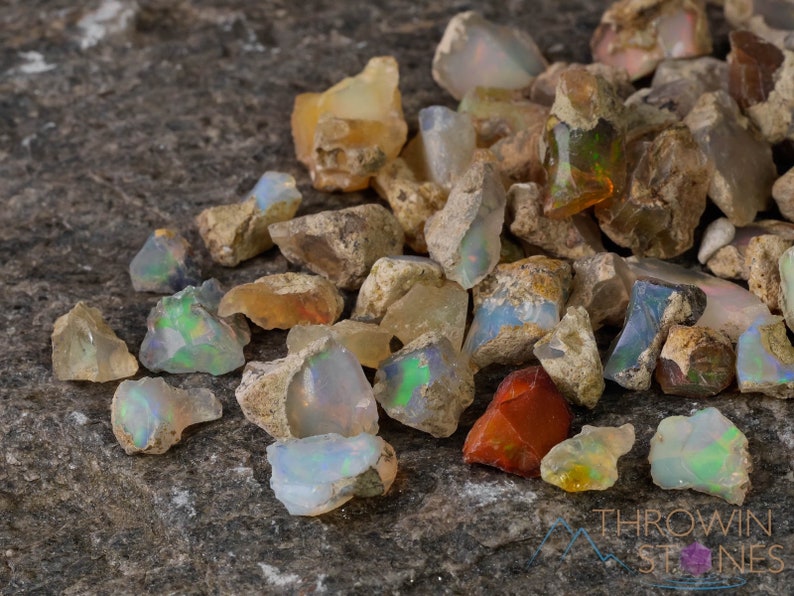 These raw Opal crystals are chunk shaped and rainbow colored with patches of tan matrix.
Crystals are nature-made therefore each one is unique in appearance.