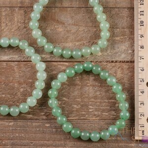 These pastel green Aventurine crystal bracelets have sphere beads strung on elastic for an endless bracelet. 
Crystals are nature-made therefore each one is unique in appearance.