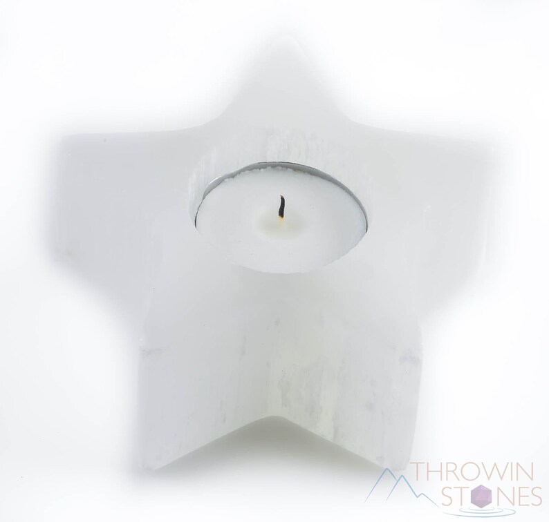 These are white Selenite crystal carved candle holders in the shape of a star.
Crystals are nature-made therefore each one is unique in appearance.