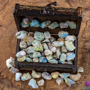 These raw Opal crystals are chunk shaped and rainbow colored with patches of tan matrix.
Crystals are nature-made therefore each one is unique in appearance.