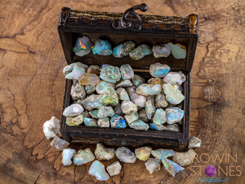 These raw Opal crystals are chunk shaped and rainbow colored with patches of tan matrix.
Crystals are nature-made therefore each one is unique in appearance.